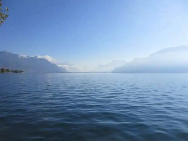 A lake with mountains behind it